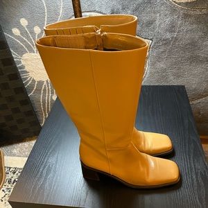 Woman’s tan long boots used.